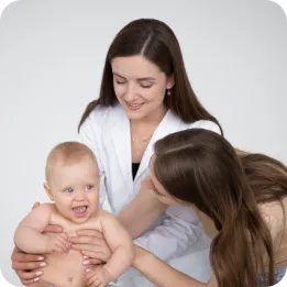 The image features a happy baby being gently held by a caregiver, while a healthcare professional, possibly a pediatrician or nurse, observes with a warm smile. It can effectively illustrate baby and caregiver services, such as pediatric home care, early childhood development, or family health support.