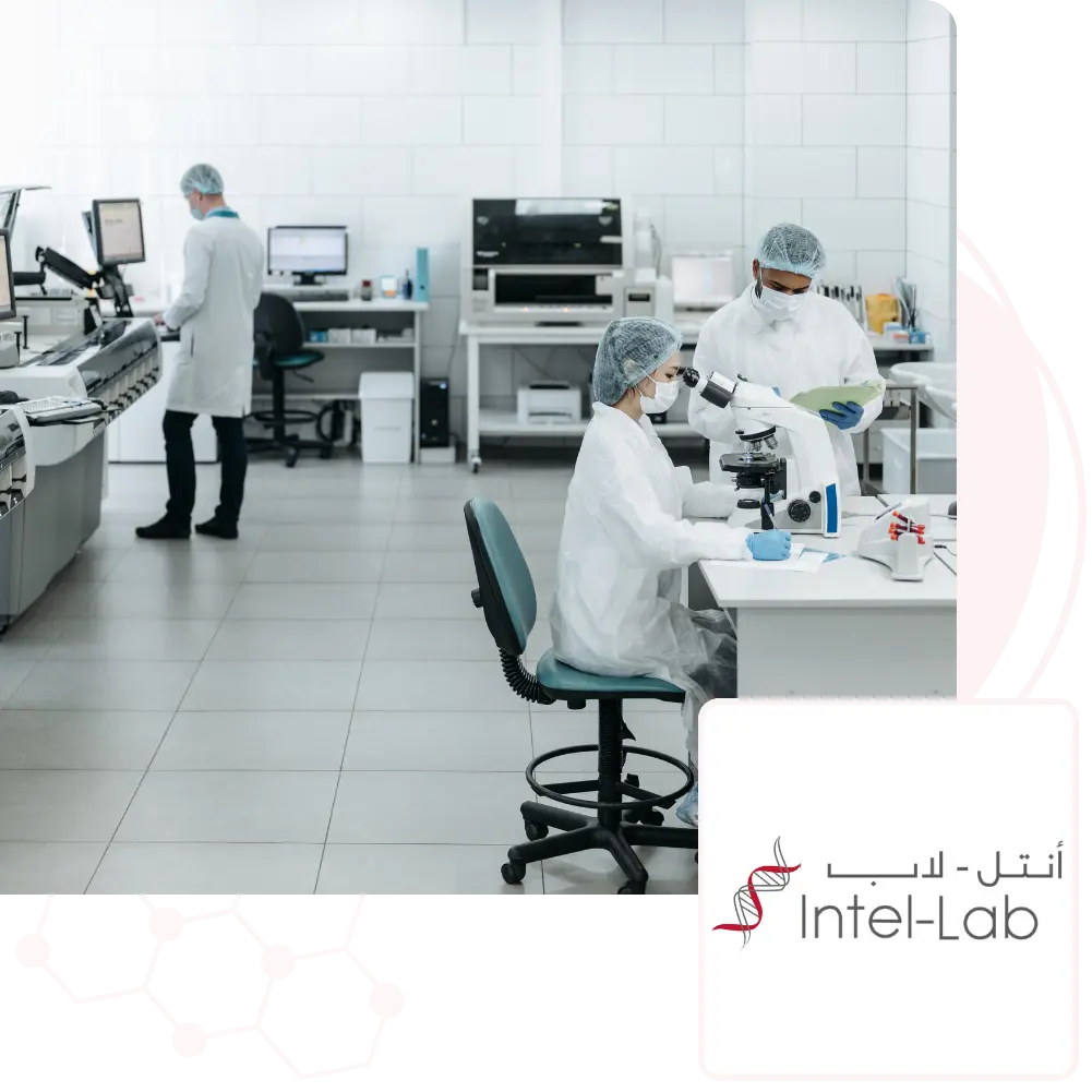A laboratory setting with three professionals in white lab coats and protective gear working at various stations. One person is seated at a microscope, another reviews data, and a third operates a computer, showcasing a high-tech medical research environment. The Intel-Lab logo with Arabic and English text is displayed in the bottom right corner.